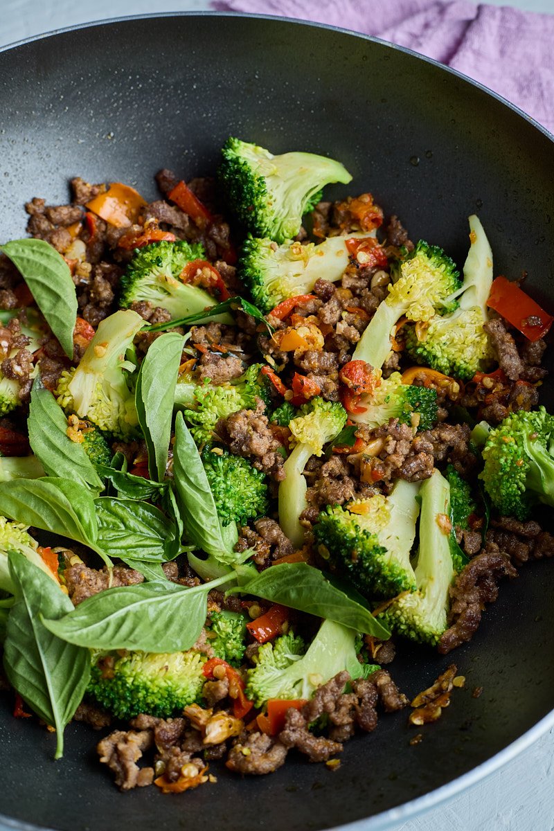 Add fresh basil in spaghetti pan.