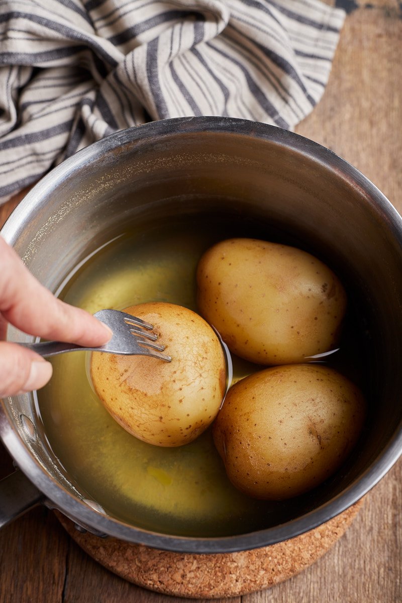 Test the potatoes for doneness.