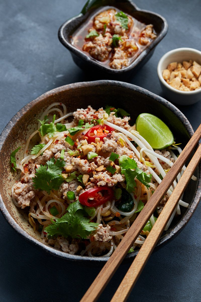 Spiced Pork Noodles with Lime Wedge and Roasted Peanut